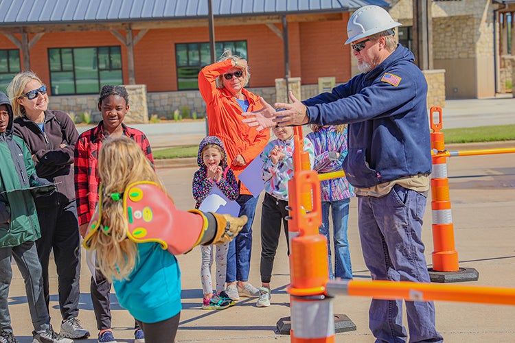 Central lineman give a safety demonstration during Co-op Kids Day.