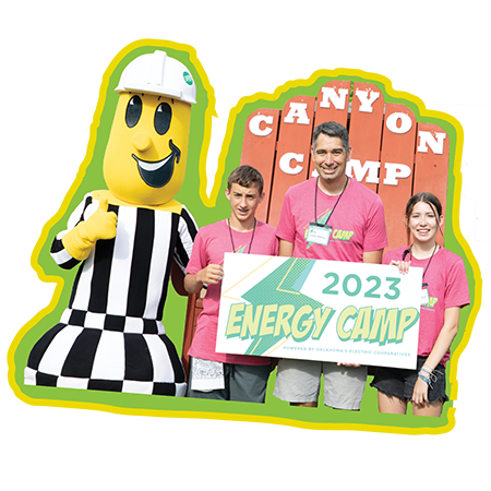 Youth Power Energy Camp participants Willow Mattox and Gavin Oliver pose with Central's Director of Communications, Larry Mattox, and the electric cooperative mascot Willie Wiredhand