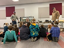 Central Linemen Kyle Williams and Jerry Cundiff present a safety demonstration to a group of elementary students at Ripley Public schools.