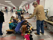 Central Linemen Kyle Williams and Jerry Cundiff present a safety demonstration to a group of elementary students at Ripley Public schools.