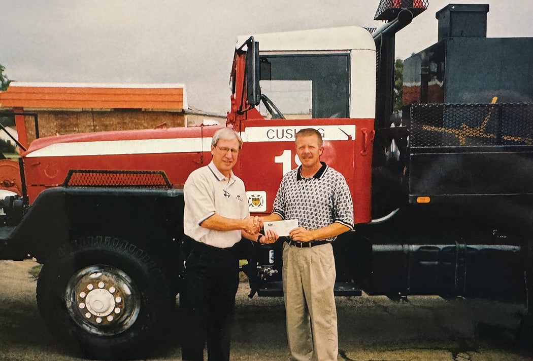 Randy Jarvis presents a Central Community Foundation grant to the Cushing Fire Department. 