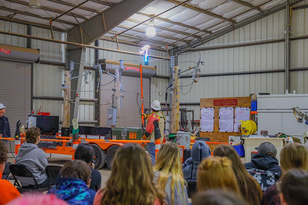 Central linemen host a live line demonstration to a group at a Stillwater FFA meeting.