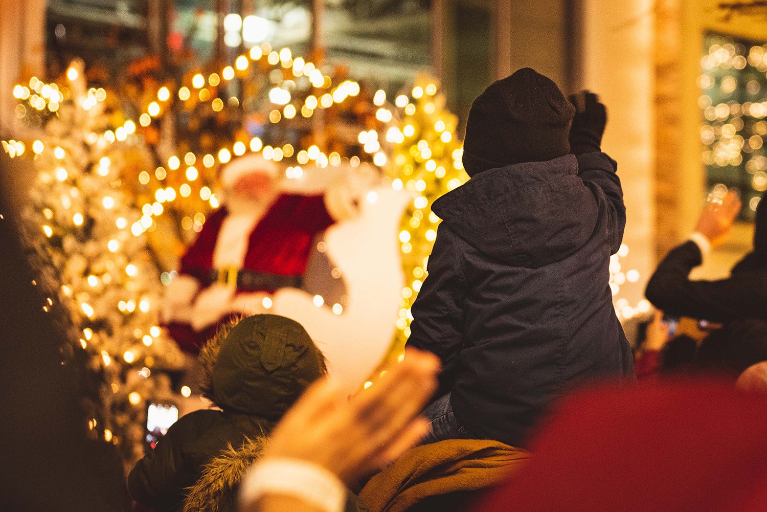 Holiday Parade with Santa waving at a child