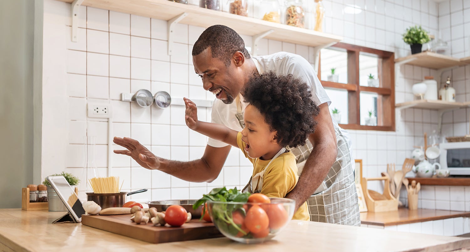 Father and son cooking in a kitchen