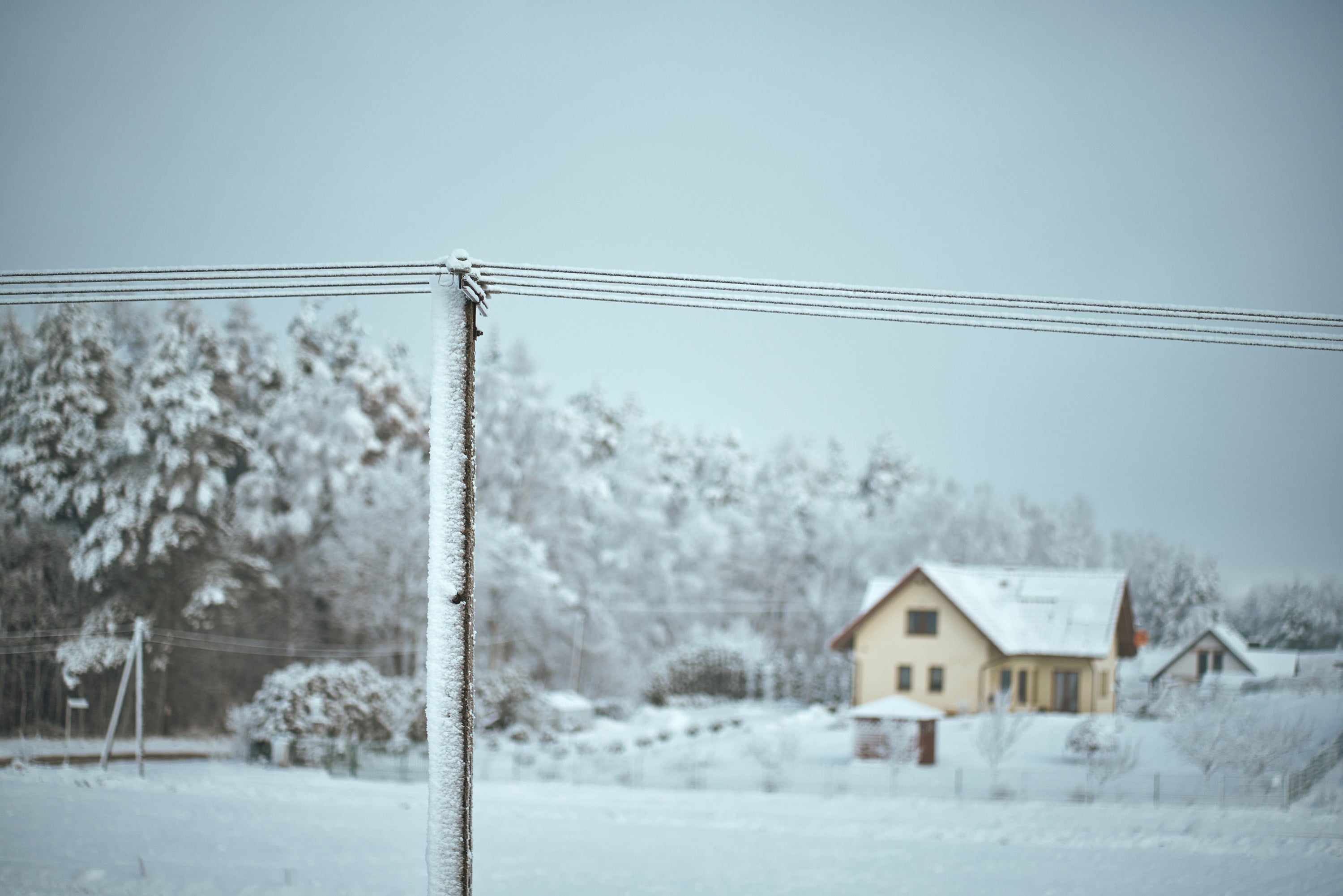 Winter scene with electric pole and house