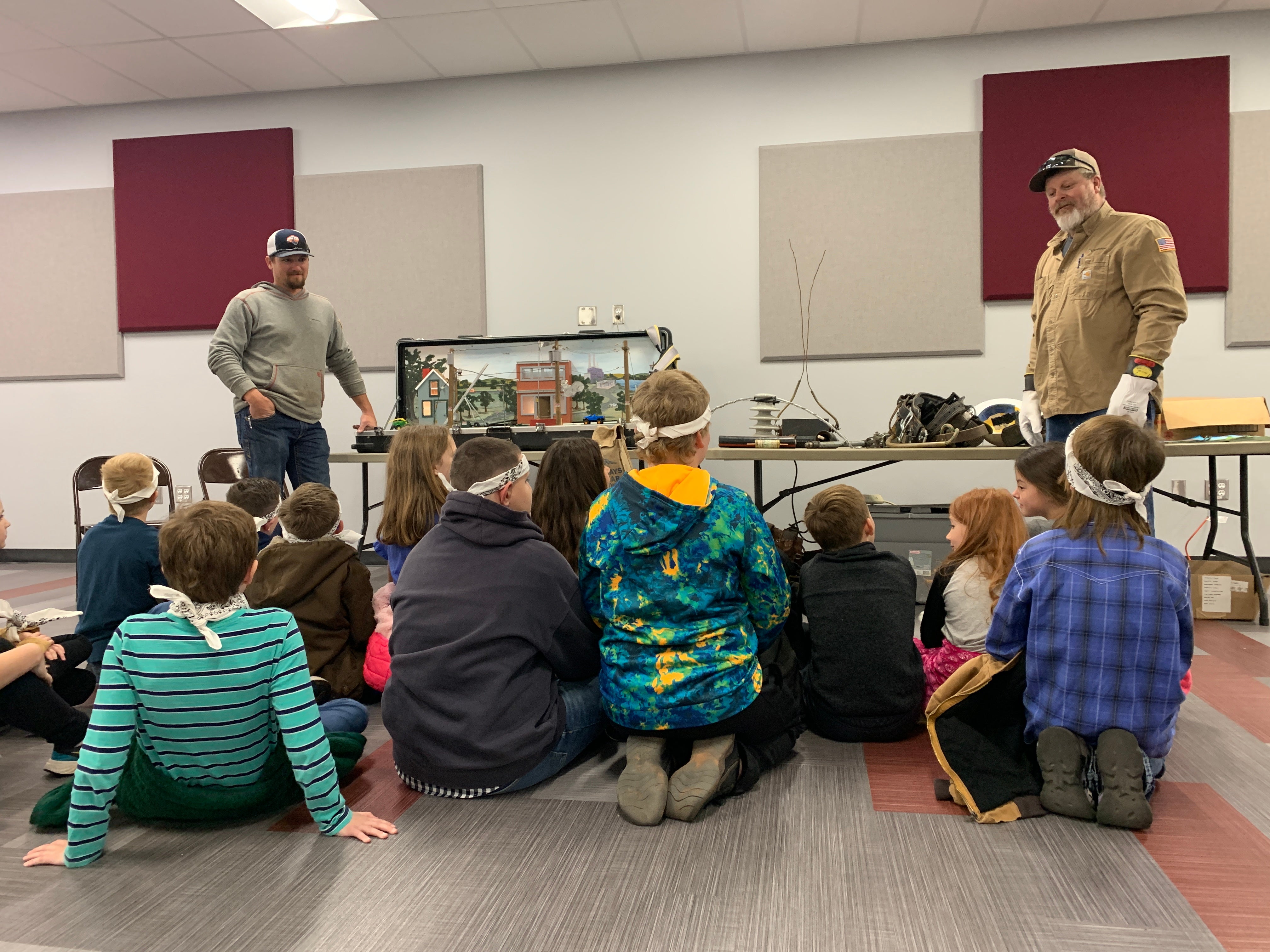 Central Linemen Kyle Williams and Jerry Cundiff present a safety demonstration to a group of elementary students at Ripley Public schools. 