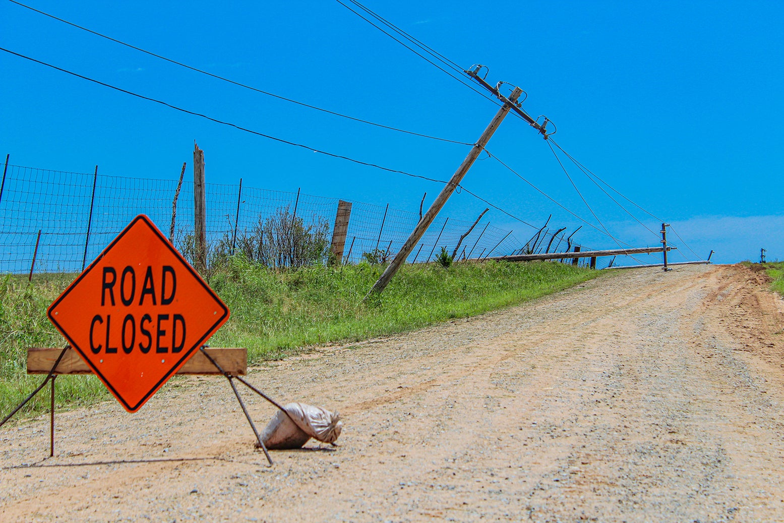 Downed power lines and road closed sign