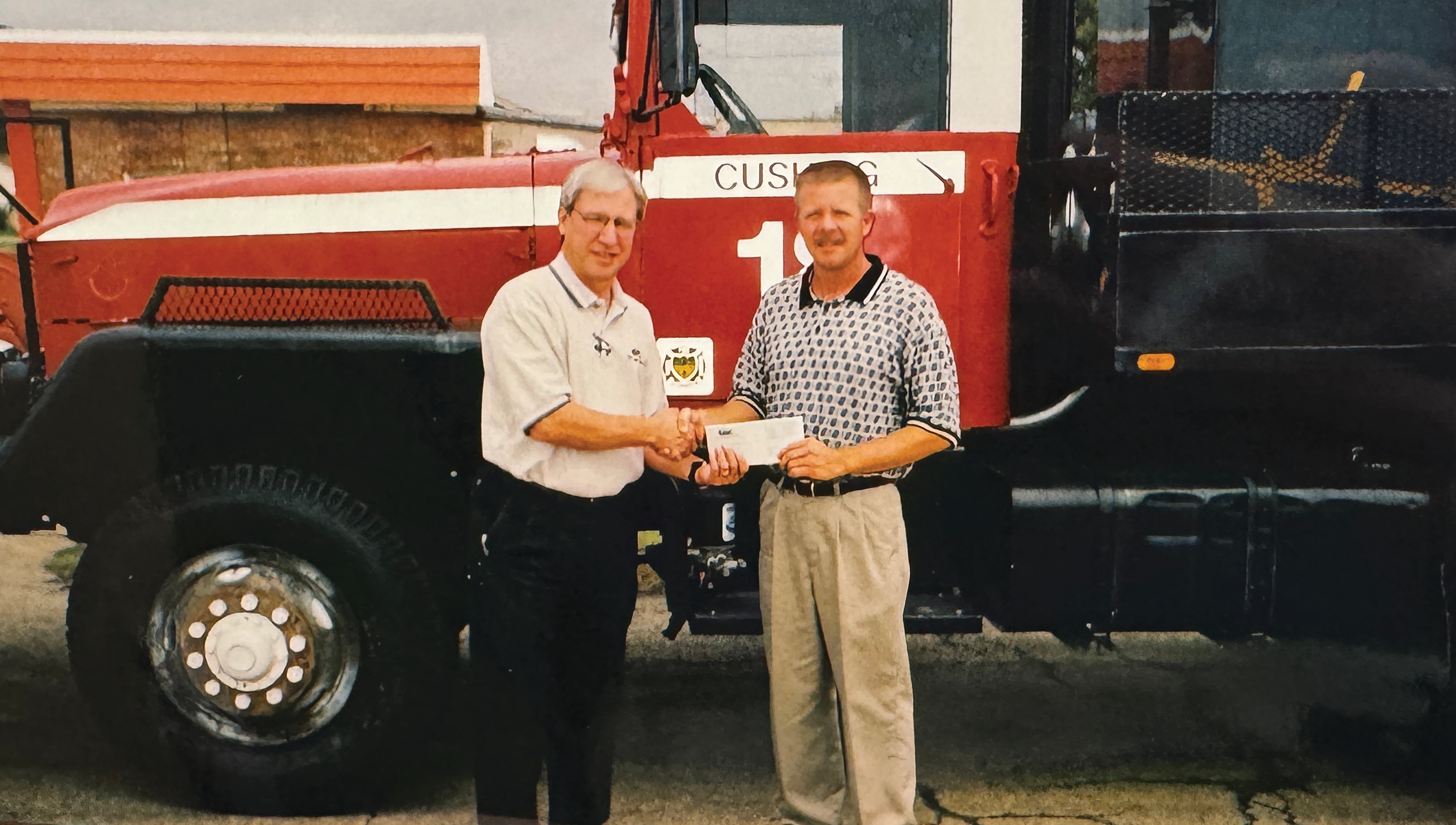 Randy Jarvis presents a Central Community Foundation grant to the Cushing Fire Department. 